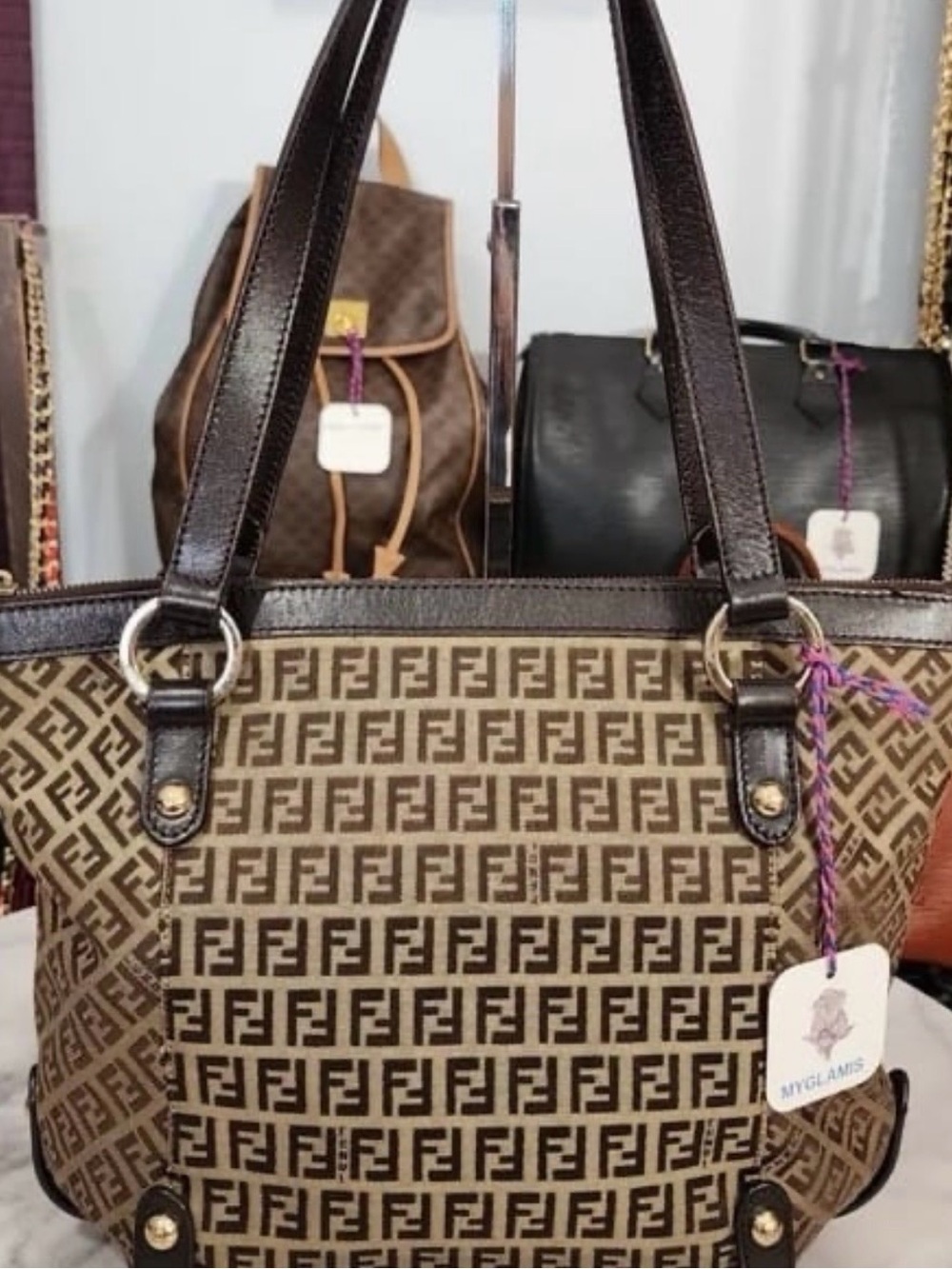 VintageFendi Zucchino FF tote featuring a monogram canvas and brown leather trim